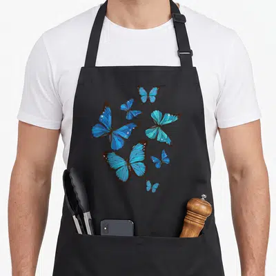 Morpho butterfly apron - Six blue butterflies with brown outlines scattered in various sizes and orientations — shown on a black cotton canvas apron against a white background