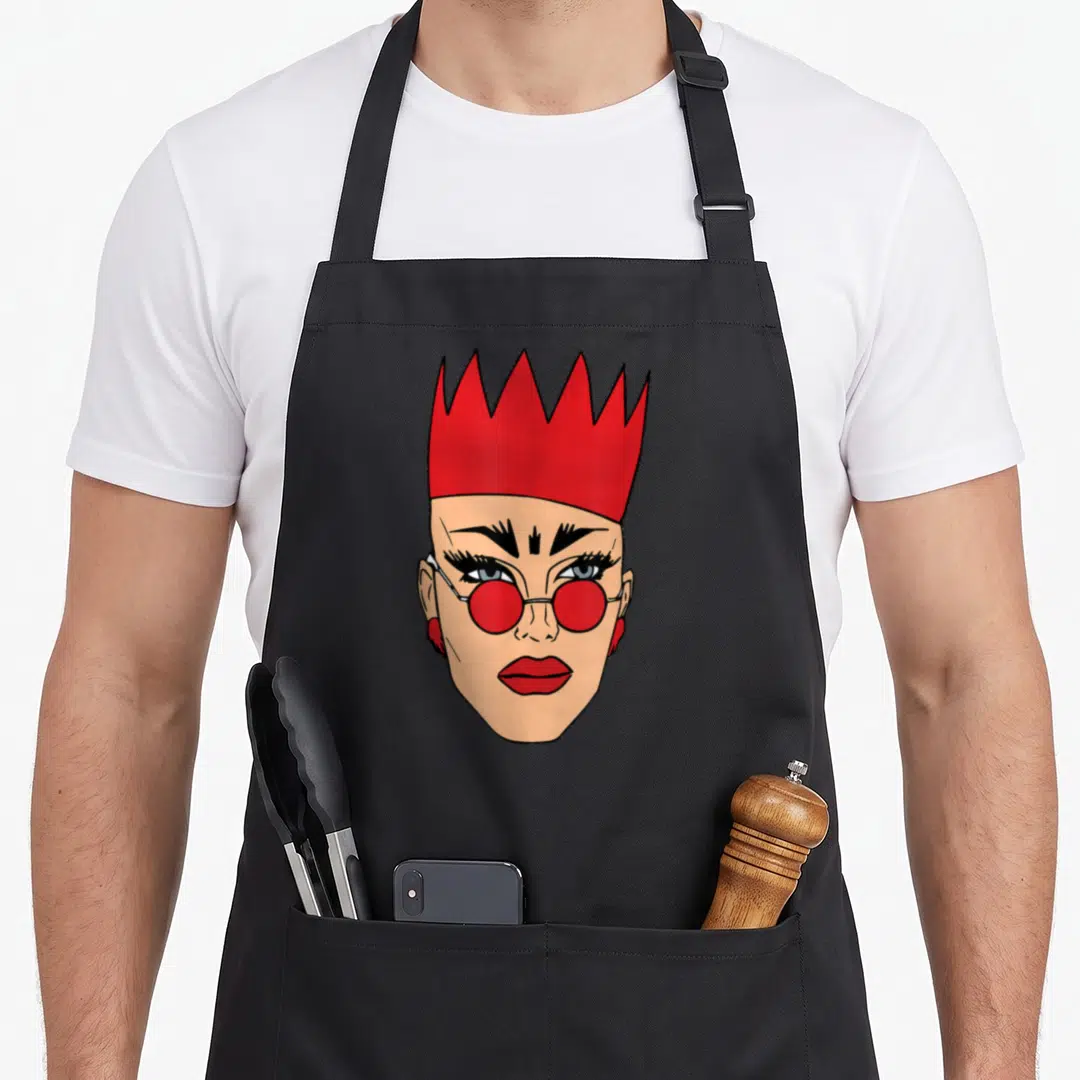 Velour queen apron - Cartoon head with red crown, red round glasses, tan skin, and black outlines — shown on a black cotton canvas apron against a white background