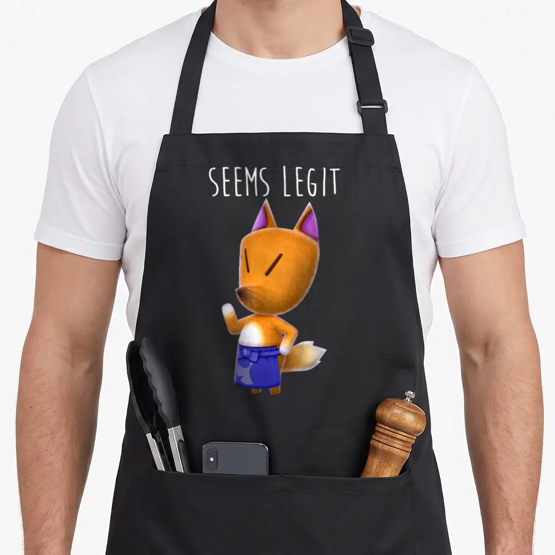 Redd fox print apron - Cartoon fox in blue skirt with SEEMS LEGIT text above — shown on a black cotton canvas apron against a white background