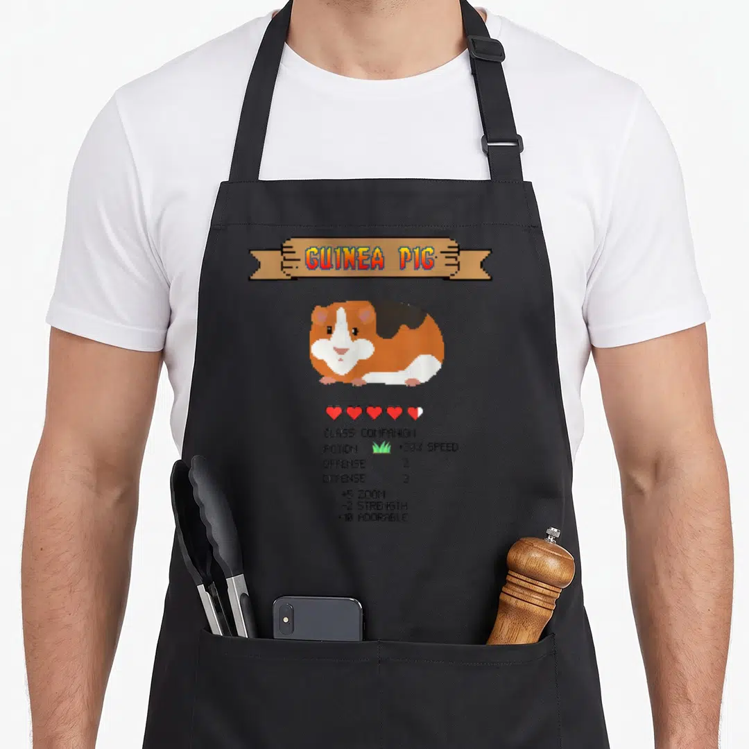 Guinea video game apron - Pixel art guinea pig with RPG stats like +10 ADORABLE and health hearts on banner — shown on a black cotton canvas apron against a white background