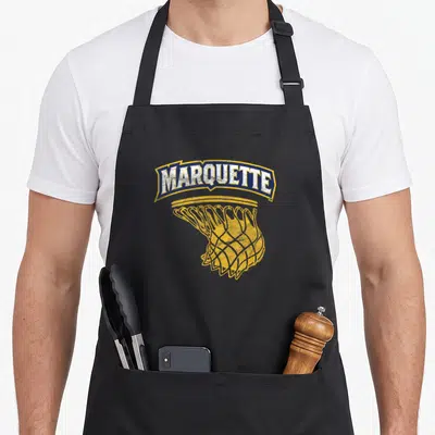 Hoop eagles apron - MARQUETTE text in blue banner above yellow basketball net with distressed texture — shown on a black cotton canvas apron against a white background