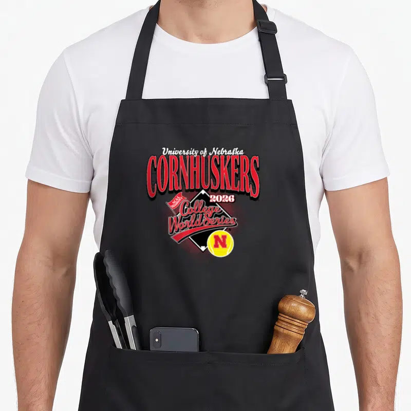 Nebraska novelty apron - University of Nebraska Cornhuskers 2026 Women's College World Series diamond softball logo — shown on a black cotton canvas apron against a white background