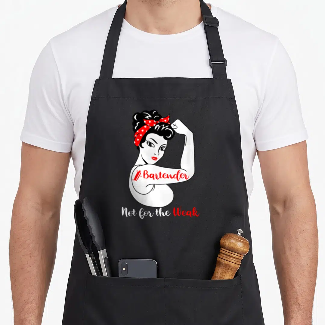 Weak bartender apron - Cartoon woman flexing with Bartender text and red star headscarf — shown on a black cotton canvas apron against a white background