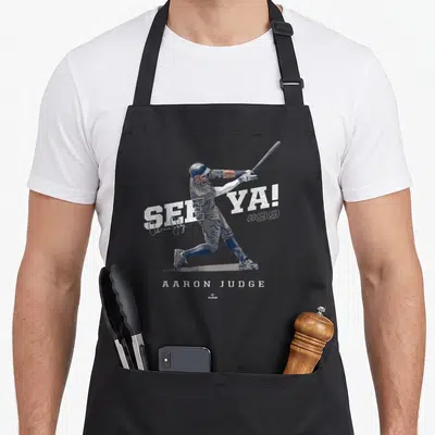 See new york apron - Aaron Judge swinging bat with See Ya text and #99 in white blue grey — shown on a black cotton canvas apron against a white background