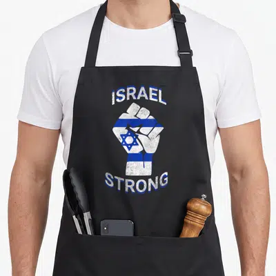 Strong jewish apron - Raised fist with blue white stripes and Star of David surrounded by arched ISRAEL STRONG text — shown on a black cotton canvas apron against a white background