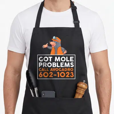 Mole engineer problems apron - Cartoon mole in orange safety gear above text GOT MOLE PROBLEMS CALL AVOGADRO 602-1023 — shown on a black cotton canvas apron against a white background
