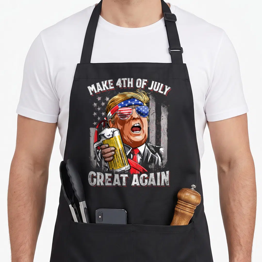 Trump drinking 4th of july apron - Cartoon man with flag bandana holding beer mug under arched text — shown on a black cotton canvas apron against a white background