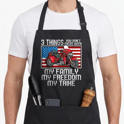 Trike biker apron - Red trike on US flag with text 3 Things You Don't Mess With My Family My Freedom My Trike — shown on a black cotton canvas apron against a white background
