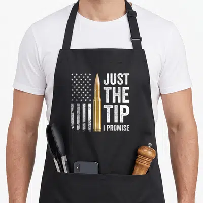 Tip pro apron - Gold bullet with distressed US flag and text Just The Tip I Promise — shown on a black cotton canvas apron against a white background