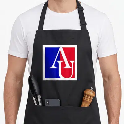 Icon eagles apron - White A and U letters overlapping on split blue and red rectangular background — shown on a black cotton canvas apron against a white background