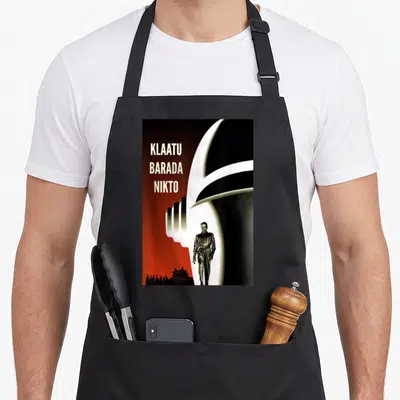 Klaatu robot lover apron - Stacked text KLAATU BARADA NIKTO beside white spaceship and man in red black retro art — shown on a black cotton canvas apron against a white background