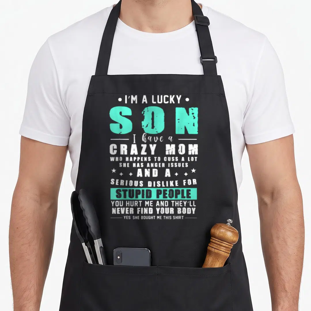 Funny lucky mom and son aprons - White and turquoise stacked text reading I'm a lucky son with a crazy mom quote — shown on a black cotton canvas apron against a white background