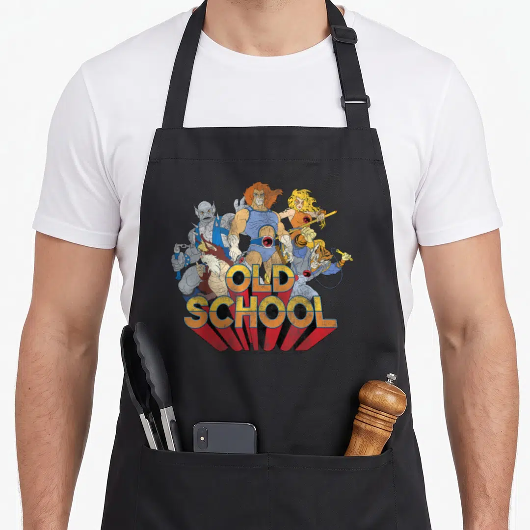 School group shot apron - Four cartoon characters behind yellow and red 3D OLD SCHOOL text — shown on a black cotton canvas apron against a white background