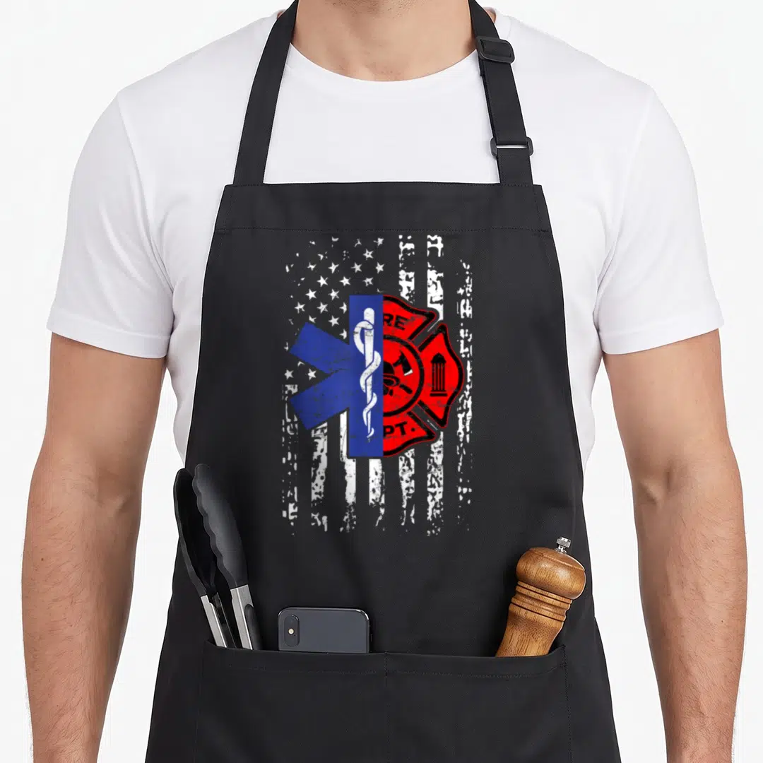 Emt american flag apron - Distressed US flag with blue Star of Life and red Fire Dept cross superimposed — shown on a black cotton canvas apron against a white background