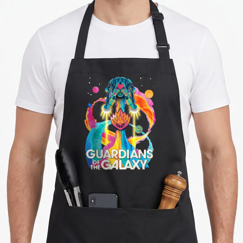 Galaxy rainbow apron - Cartoon robot with colorful swirls and GUARDIANS OF THE GALAXY text — shown on a black cotton canvas apron against a white background