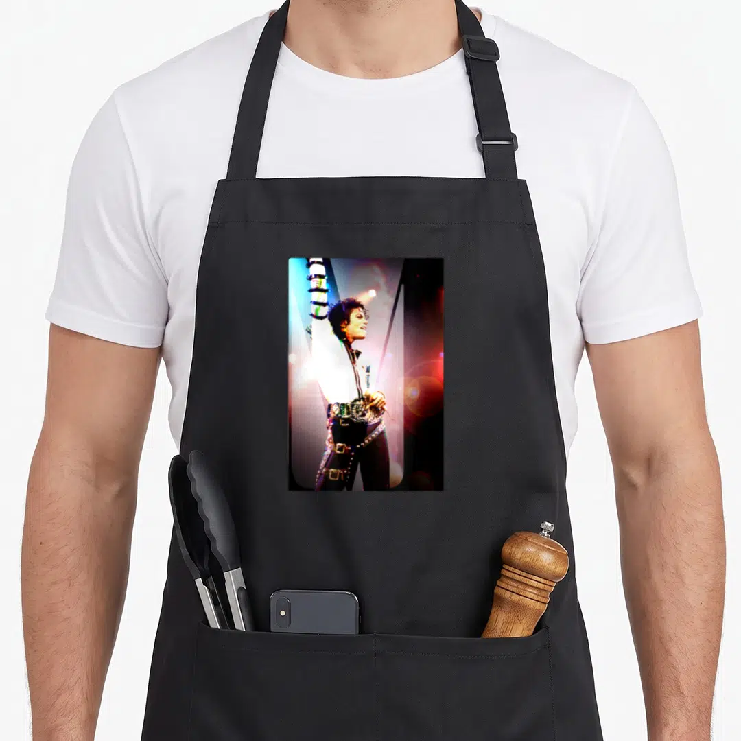 Jackson michaels apron for men - Photo of Michael Jackson on stage with one arm raised wearing a white jacket — shown on a black cotton canvas apron against a white background