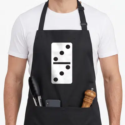 Dominoe halloween apron - Vertical white domino tile with three black dots on top and three on bottom — shown on a black cotton canvas apron against a white background