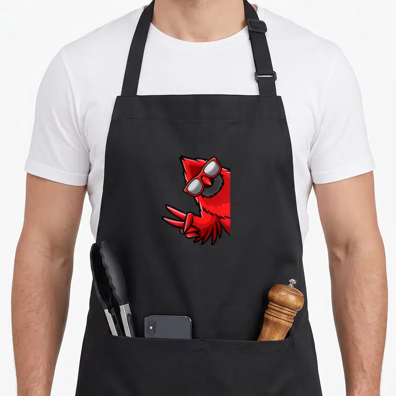 Northern bird cardinal apron - Red cartoon cardinal with sunglasses and peace sign claws on black apron — shown on a black cotton canvas apron against a white background