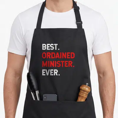Minister wedding apron - Stacked white and red text reading best ordained minister ever — shown on a black cotton canvas apron against a white background