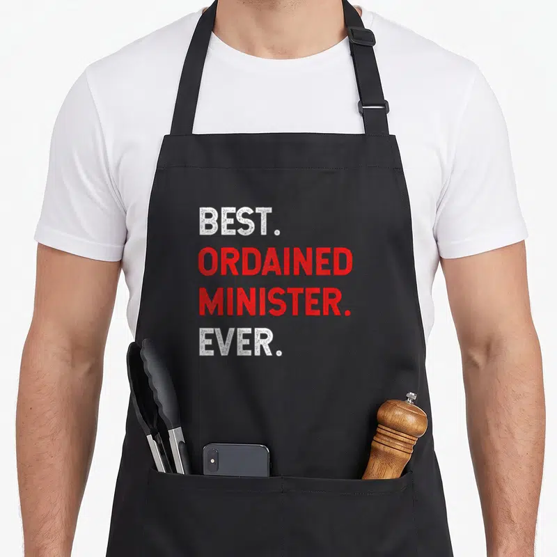 Minister wedding apron - Stacked white and red text reading best ordained minister ever — shown on a black cotton canvas apron against a white background