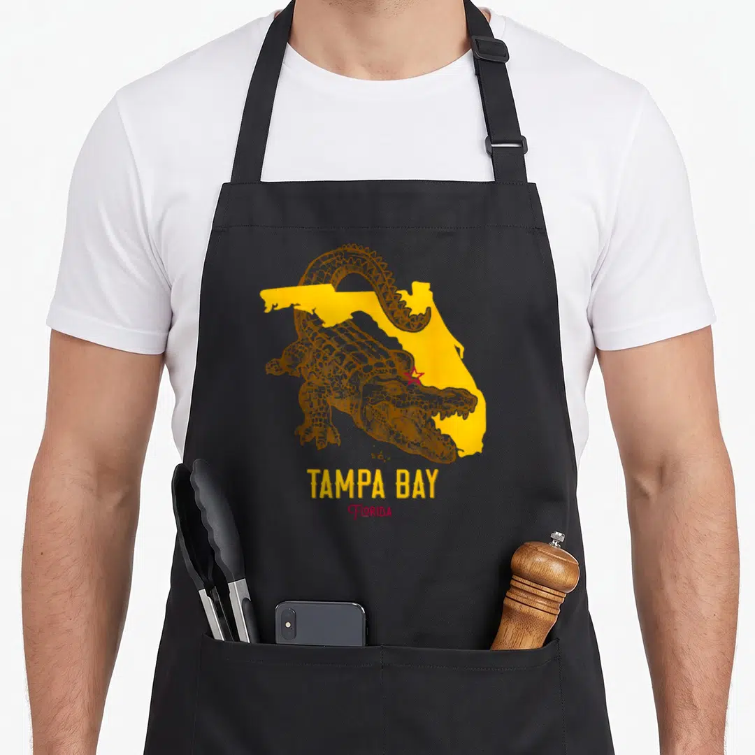 Aligator florida apron - Brown alligator over yellow Florida map with red star and centered text — shown on a black cotton canvas apron against a white background