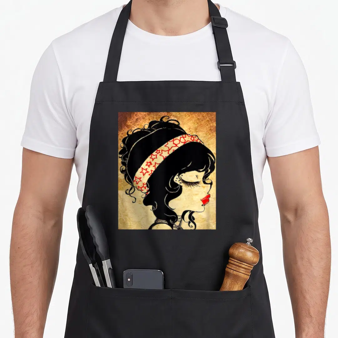 Thrifter rockabilly apron - Minimalist woman profile with red star headband on beige background — shown on a black cotton canvas apron against a white background