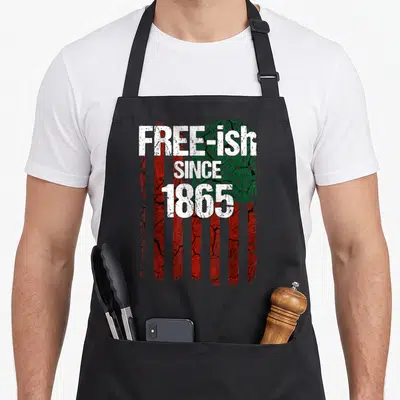 Free pride apron - Distressed red white and green flag with free-ish since 1865 text stacked vertically — shown on a black cotton canvas apron against a white background