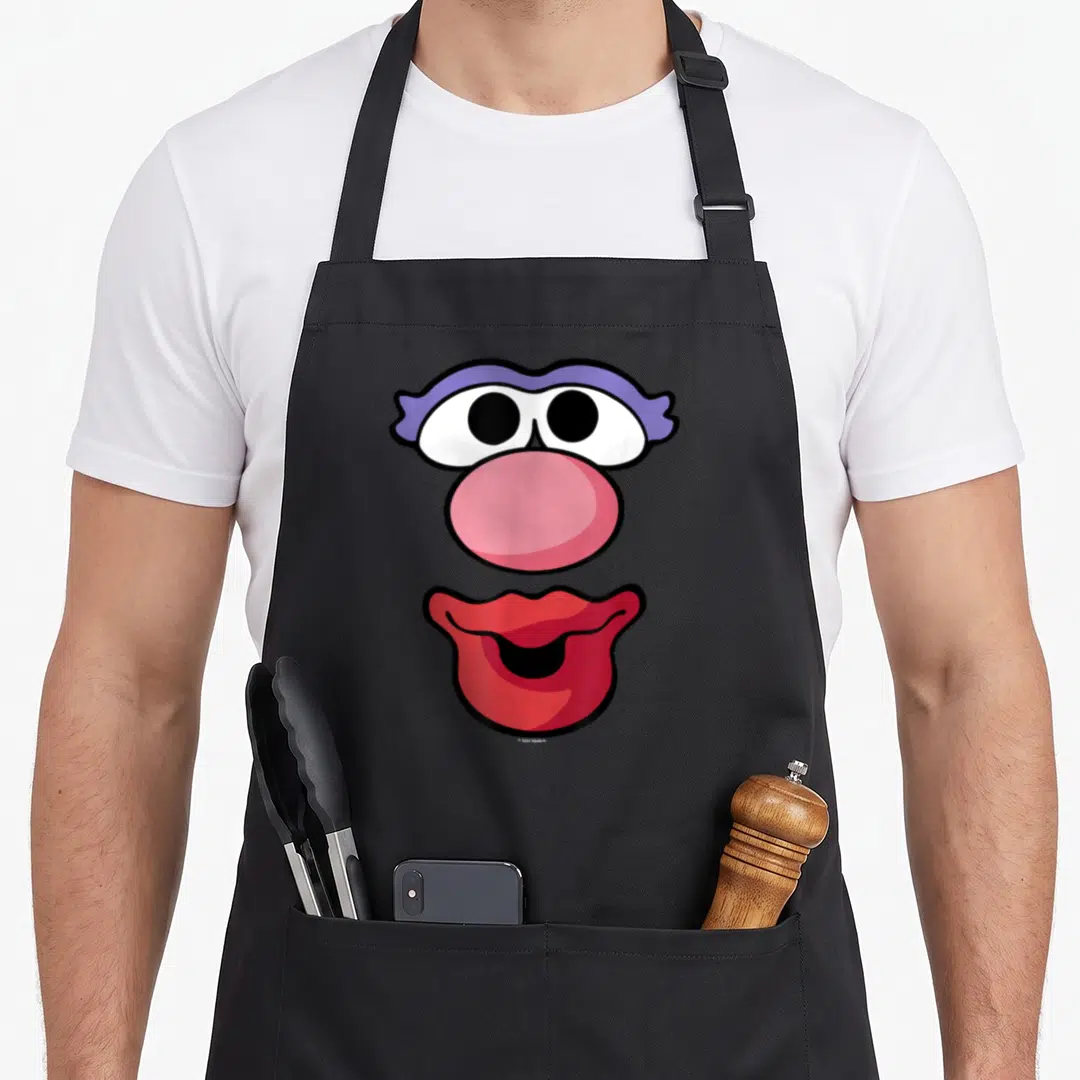 Potato mr mrs aprons - Cartoon face with purple eye lids, pink nose, and red lips arranged vertically — shown on a black cotton canvas apron against a white background