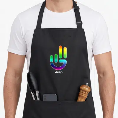 Jeep pride apron - Rainbow hand symbol above white Jeep text on cotton canvas — shown on a black cotton canvas apron against a white background