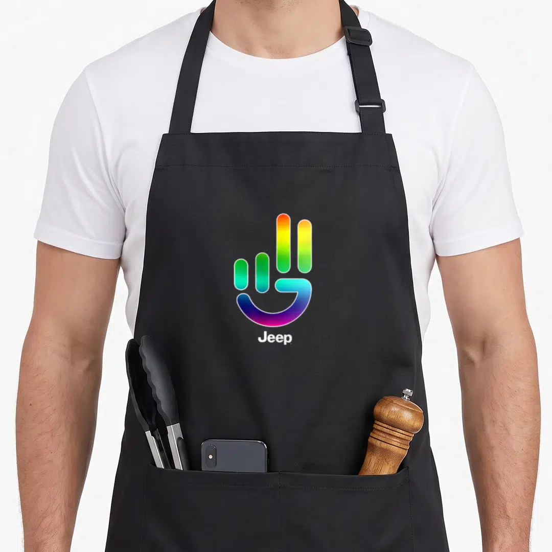 Jeep pride apron - Rainbow hand symbol above white Jeep text on cotton canvas — shown on a black cotton canvas apron against a white background
