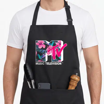 Mtv hummingbird apron - MTV logo filled with pink hibiscus and blue hummingbirds above white text — shown on a black cotton canvas apron against a white background