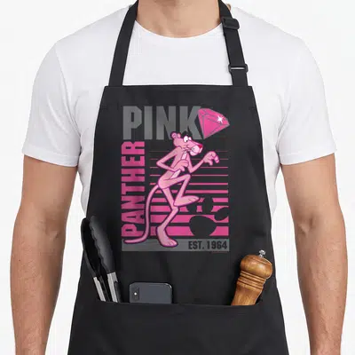 Portrait lined apron - Retro Pink Panther character standing centrally over grey PINK text and vertical pink PANTHER — shown on a black cotton canvas apron against a white background
