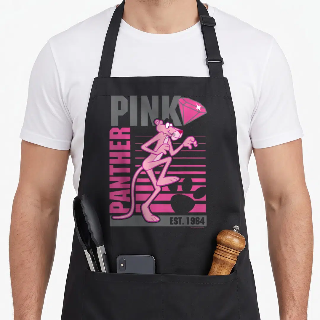 Portrait lined apron - Retro Pink Panther character standing centrally over grey PINK text and vertical pink PANTHER — shown on a black cotton canvas apron against a white background