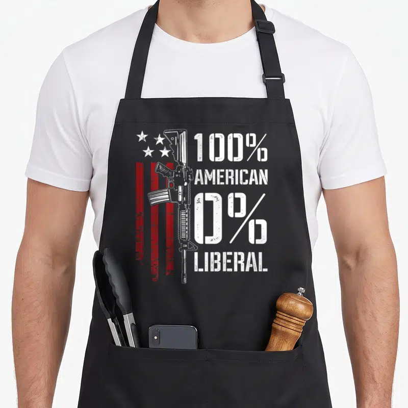 Liberal pro apron - Vertical rifle next to red stripes and stars with 100% American 0% Liberal text — shown on a black cotton canvas apron against a white background