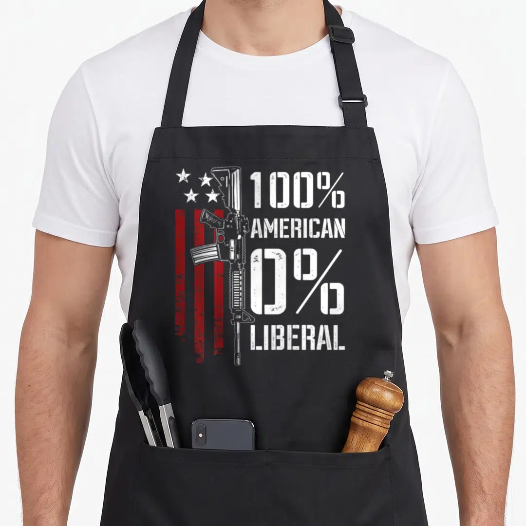 Liberal pro apron - Vertical rifle next to red stripes and stars with 100% American 0% Liberal text — shown on a black cotton canvas apron against a white background