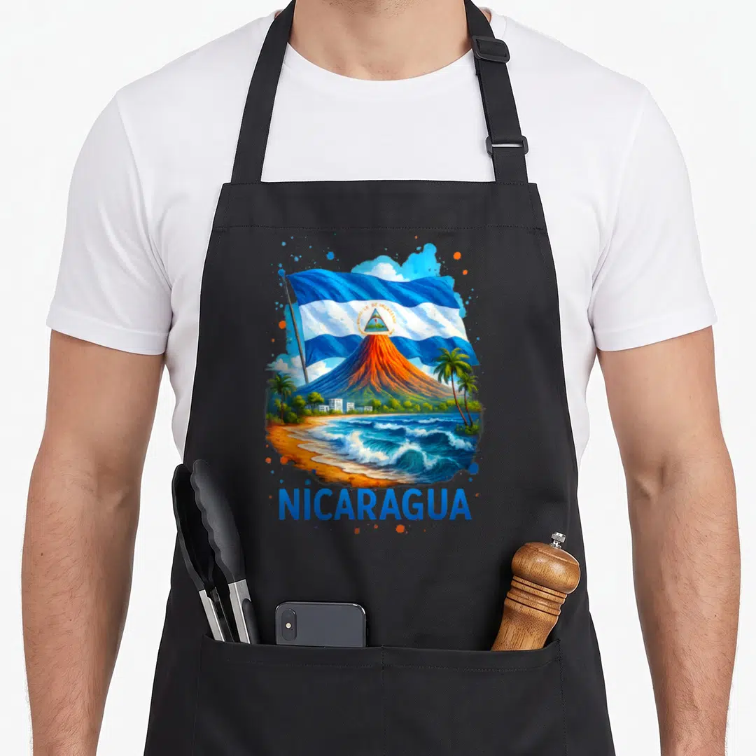 Nicaragua hispanic aprons - Volcano, beach, and waving flag illustration with NICARAGUA text in blue, orange, white — shown on a black cotton canvas apron against a white background