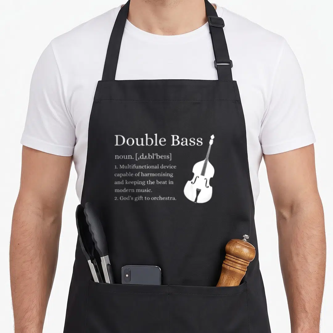 Definition double apron - White dictionary definition text and double bass silhouette on black fabric — shown on a black cotton canvas apron against a white background